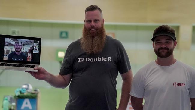 The bearded Dan Repacholi and Sergei Evglevski, right, on the podium in Brisbane with Baily Groves on the laptop from Perth