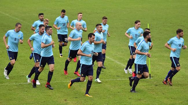 Australian players jog during a training session.