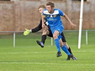 CLOSE CONTEST: South West Queensland Thunder striker Chris Hatfield rounds Gold Coast United keeper Luka Zoric during their match earlier this season. Picture: Kevin Farmer