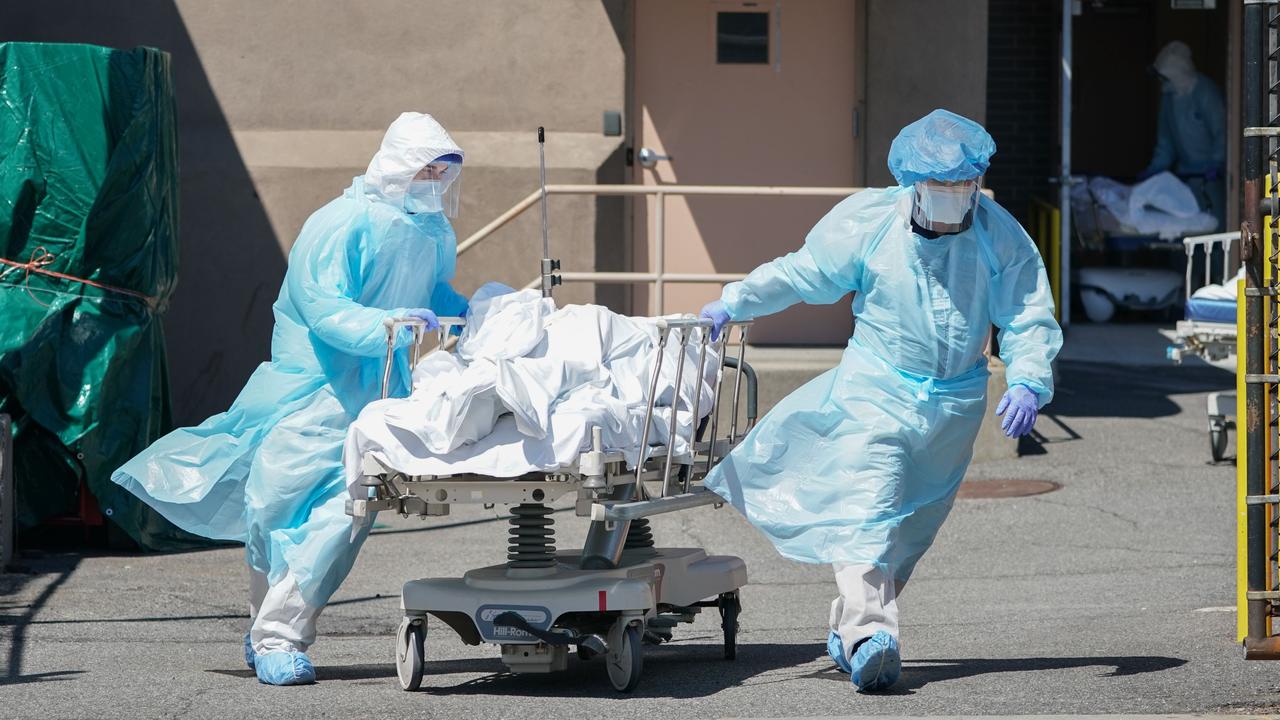 Bodies are moved to a refrigeration truck serving as a temporary morgue at Wyckoff Hospital in the Borough of Brooklyn, New York in April. Picture: Bryan R. Smith/AFP