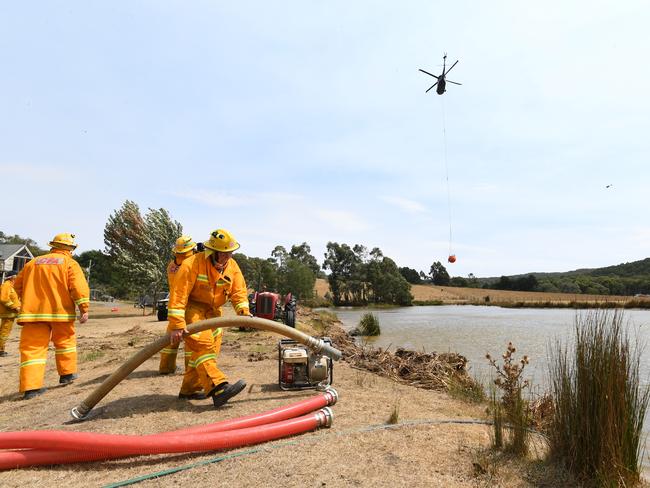 CFA firefighters prepare a pump at a dam in Gembrook. Picture: AAP