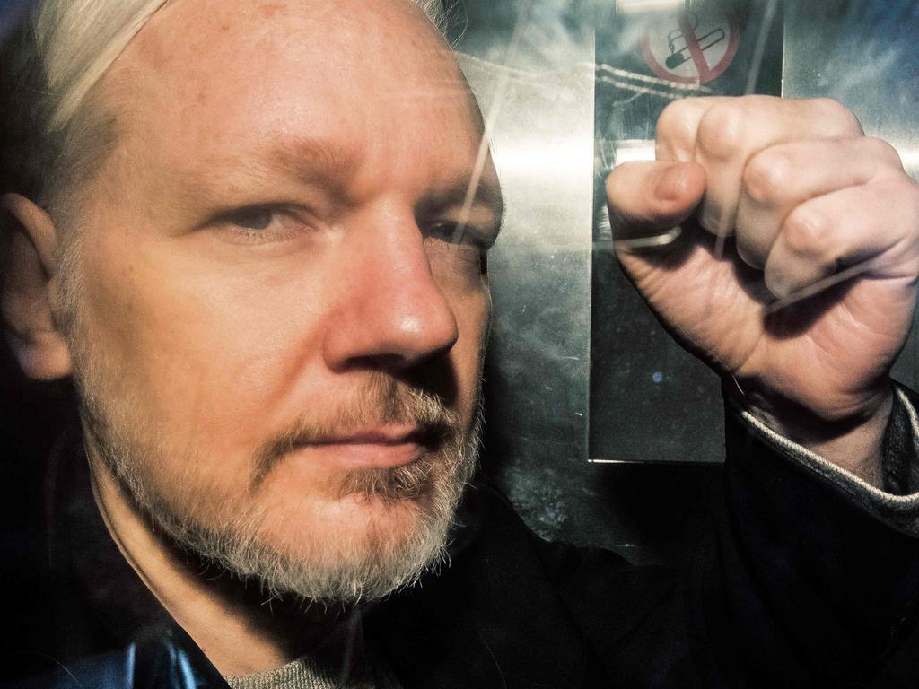 Julian Assange gestures from the window of a prison van as he is driven out of Southwark Crown Court in London, after having been sentenced to 50 weeks in prison for breaching his bail conditions in 2012. Picture: Daniel Leal-Olivas/AFP