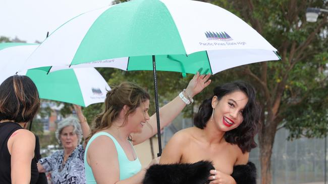 Pacific Pines High formal, at the school. Staff try to keep Stellar Stewart Tahere dry Picture Glenn Hampson