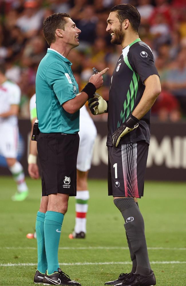 Ben Williams and Iran's goalkeeper Ali Reza Haghighi share a laugh.