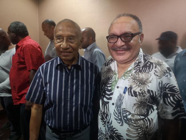 Papua New Guinea Prime Minister Peter O'Neil (R) and member of parliament Julius Chan (L) attend a function in Port Moresby on May 26, 2019. - O'Neill annouced his resignation making way for Julius Chan to return as prime minister local media reported. (Photo by GORETHY KENNETH / AFP)