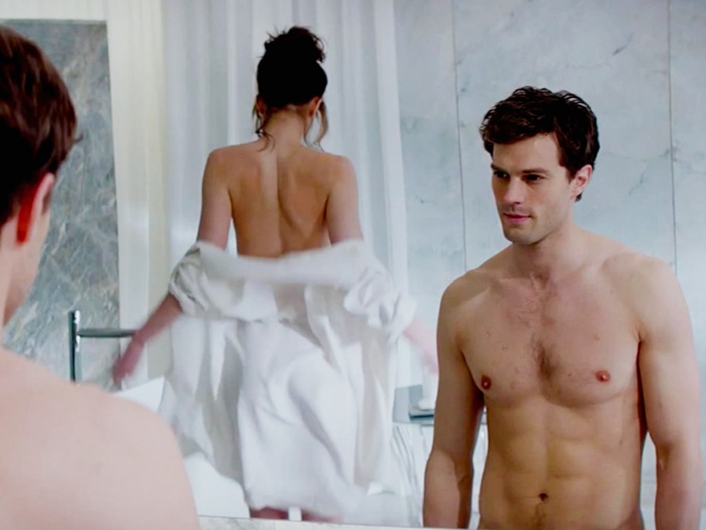 English actor Jamie Dornan takes a shirtless break from his stylish suits in the 50 Shades of Grey movie trailer with Dakota Fanning. Picture: Supplied