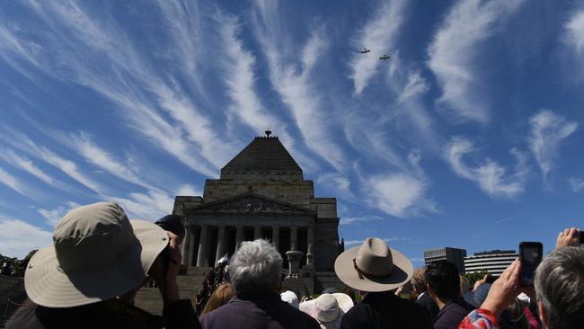 Attendees observe planes flying over the Shrine of Remembrance. Picture: AAP Image/James Ross