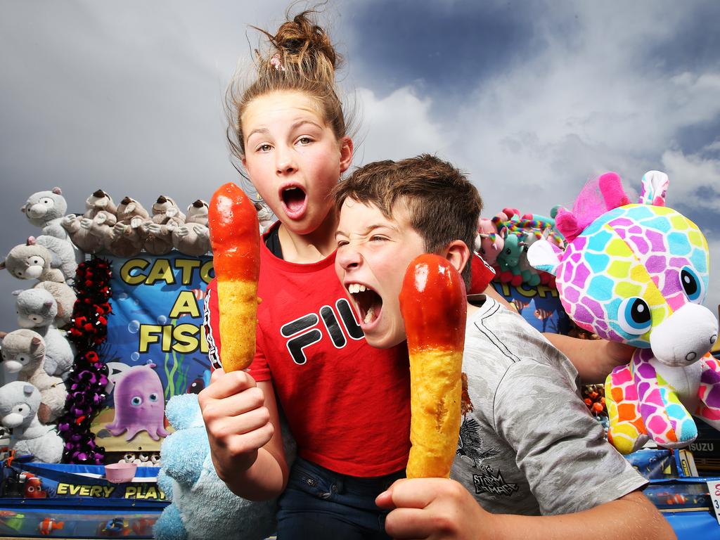 Siblings Beatrice and Ethan Chelkowski dagwood dogs at the Royal Hobart Show in 2019. Picture: Zak Simmonds