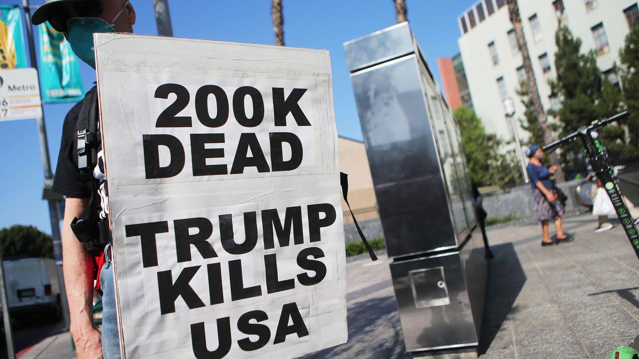 A protester in Los Angeles as the coronavirus death toll reaches 200,000. Picture: Mario Tama/Getty Images/AFP