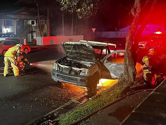 Firefighters battle the car blaze on Nebo Rd, Mackay.