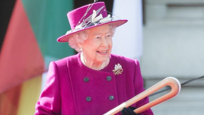 Queen Elizabeth II holds the Commonwealth baton during the launch of The Queen's Baton Relay. (Photo by Samir Hussein/Samir Hussein/WireImage).