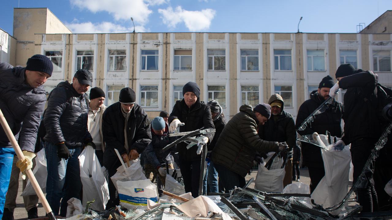 Residents volunteered to remove the rubble from the school which got damaged by rocket debris in Kyiv. Picture: Anastasia Vlasova/Getty Images