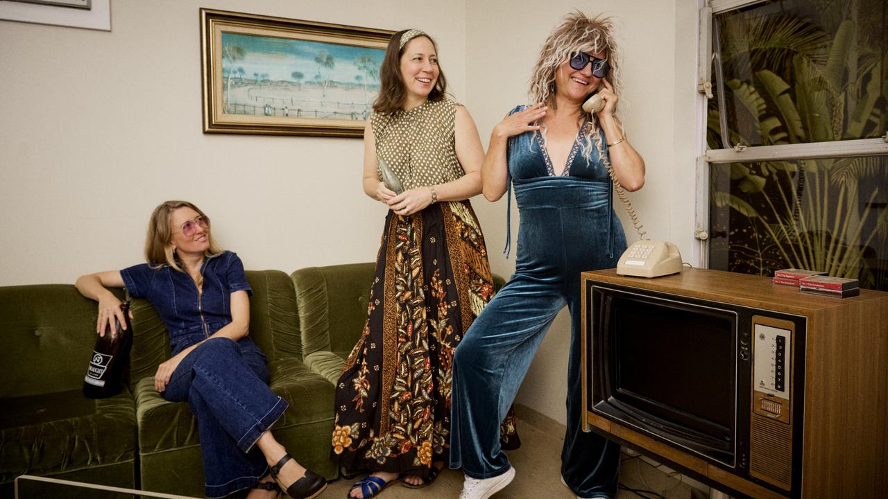 Caddie Brain (Cyclone Tracy Exhibition Project Manager), Kellie Josig (Exhibitions Manager) and Nicole Ogilvie (Marketing and Communications Manager) dressed in their 70s-themed outfits ahead of MAGNT Selfie Day. Picture: Georgina Campbell