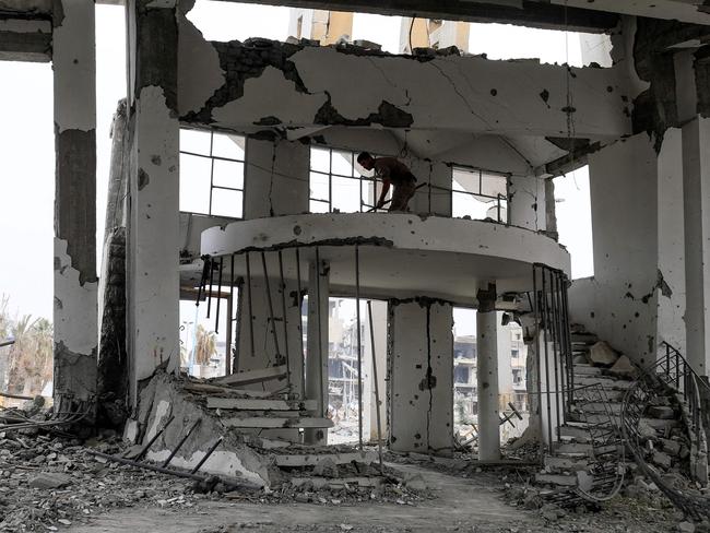 A member of Roj Mine Control Organisation looks for explosives in a heavily-damaged church in Raqqa two months after the city was liberated from IS control. Picture: Delil Souleiman/AFP