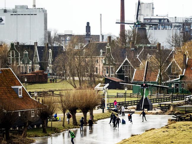 Ice skaters skate on natural ice at the Dutch ‘Zaanse Schans’ near Zaandam on March 1, 2018. Heavy snowfall and deadly blizzards lashed Europe, forcing airports to cancel or delay flights around the continent, as a deep freeze gripped countries from the far north to the Mediterranean beaches in the south. Picture: AFP