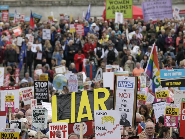 Demonstrators carried signs and banners as they gathered in Trafalgar Square, central London, to rally against the state visit of the US President: AP Photo/Tim Ireland