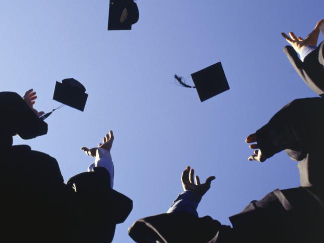 Generic image of university students. University students throwing mortar boards in the air.