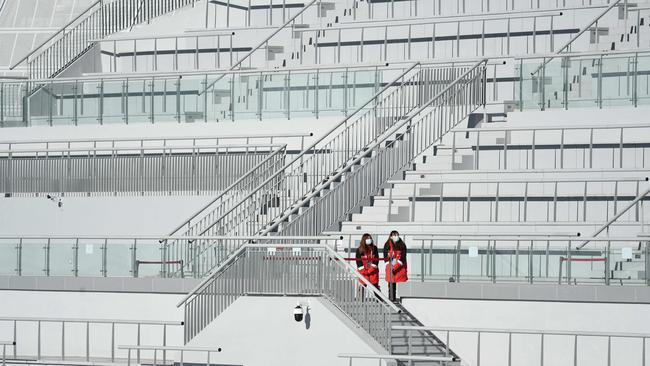 Volunteers watch during the FIS Nordic Combined Continental Cup 2021/2022, part of a 2022 Beijing Winter Olympic Games test event at the National Ski Jumping Centre.