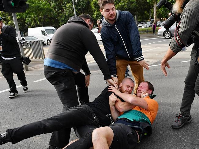 Two men wrestle on the ground in Kensington before Milo Yiannopoulos’ appearance. Picture: Jake Nowakowski