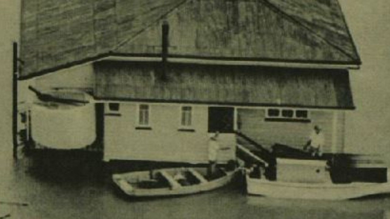 Home submerged during the 1955 flood, Maryborough. A house surrounded by floodwaters, with residents navigating by rowboat. Source: Unknown