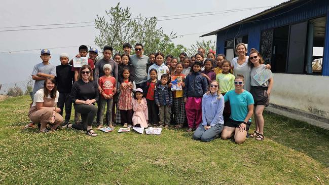 Som Tamang with children and volunteers on his return to Batase to mark the ninth anniversary of the earthquake. Picture: Kirsty Nancarrow