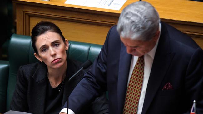 New Zealand Prime Minister Jacinda Ardern (left) listens as Deputy Prime Minister Winston Peters addresses a parliament session to pay respects to those who lost their lives in the Christchurch mosque attacks. Picture: AFP