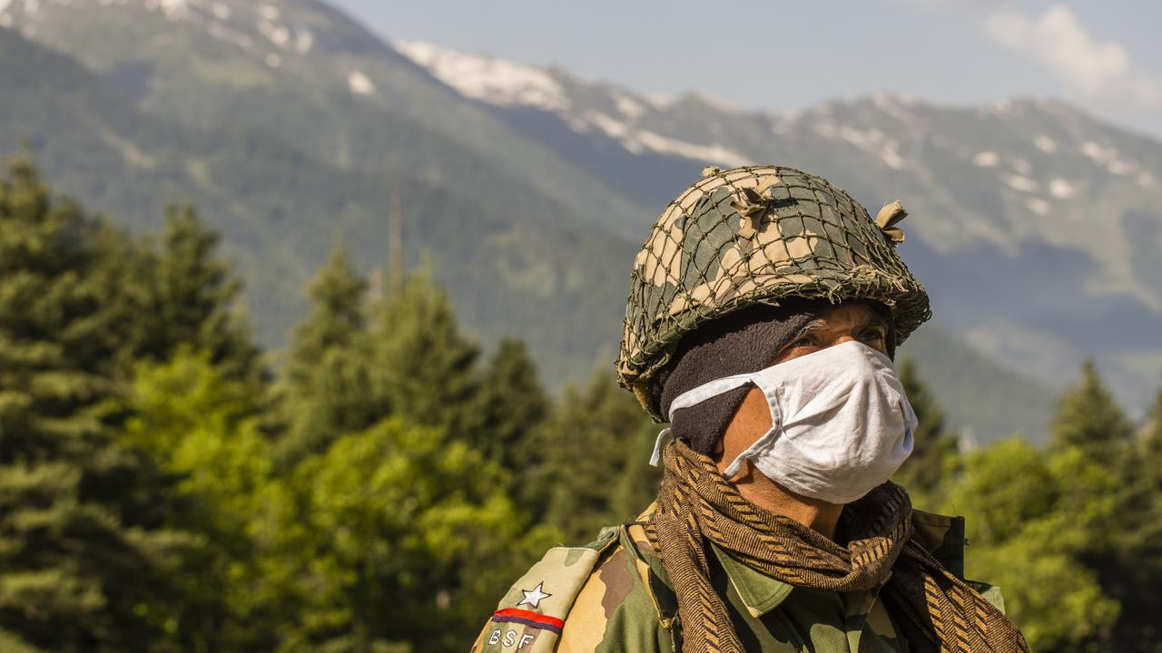 An Indian soldier guards a highway as Indian army convoy makes way towards Leh, bordering China. Picture: Yawar Nazir/Getty Images.