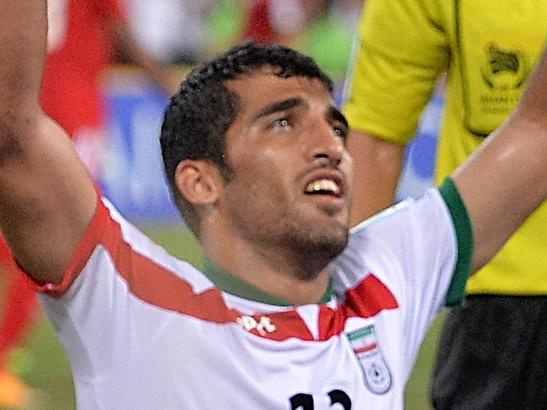 BRISBANE, AUSTRALIA - JANUARY 19: Reza Ghoochannejhad (L) of Iran is congratulated by team mates after scoring a goal during the 2015 Asian Cup match between IR Iran and the UAE at Suncorp Stadium on January 19, 2015 in Brisbane, Australia. (Photo by Bradley Kanaris/Getty Images)