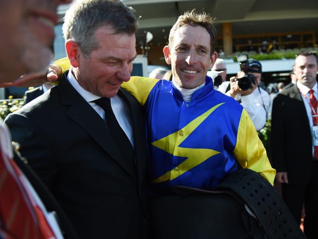 Hugh Bowman celebrates with trainer Kris Lees. Picture: AAP