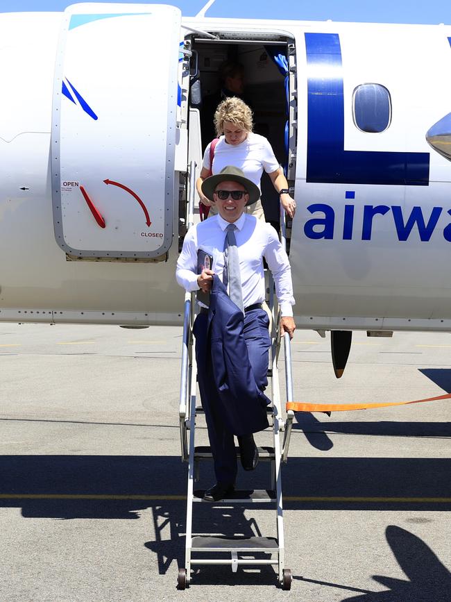 Queensland Premier Steven Miles and his wife Kim McDowell depart from his plane after landing in Townsville at the start of the Queensland election campaign. Picture: Adam head