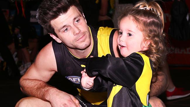 Cotchin celebrating a Tigers win in the rooms with his daughter. Picture: Getty