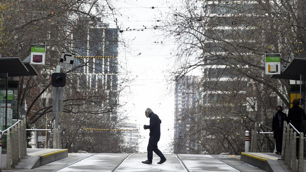 A lone pedestrian crosses Bourke St in central Melbourne during a five day lockdown. Picture: NCA NewsWire/Andrew Henshaw