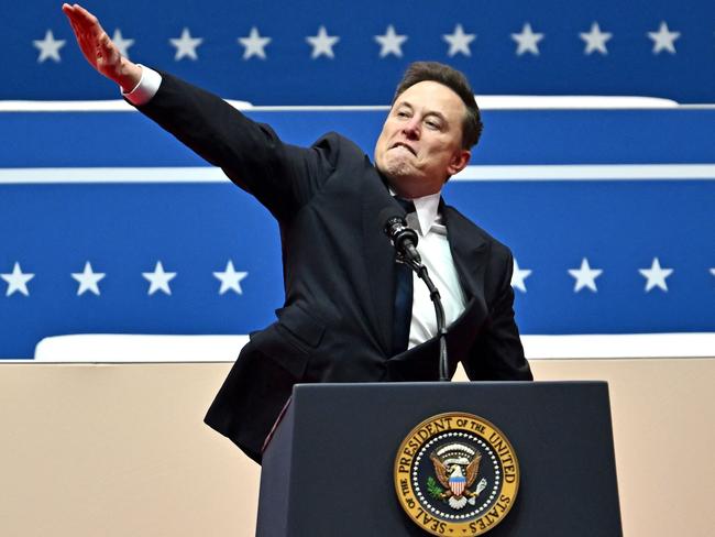 (FILES) Tesla and SpaceX CEO Elon Musk gestures as he speaks during the inaugural parade inside Capitol One Arena, in Washington, DC, on January 20, 2025. Musk's hand gestures at an inauguration event for US President Donald Trump, which quickly drew comparisons to Nazi salutes, appear to have resonated in some far-right extremist spaces online. Several neo-Nazi leaders have shared clips of the viral moment from Musk's Monday speech, in which the billionaire brought his hand to his chest and extended it straight out, twice, before saying: "My heart goes out to you." (Photo by ANGELA WEISS / AFP)