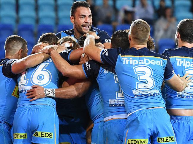 Titans captain Ryan James is seen as players celebrate the winning try during the Round 1 NRL match between the Gold Coast Titans and the Canberra Raiders at Cbus Super Stadium in Robina on the Gold Coast, Sunday, March 11, 2018. (AAP Image/Dave Hunt) NO ARCHIVING, EDITORIAL USE ONLY