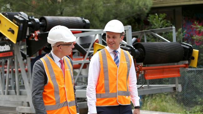 Federal Minister Paul Fletcher and Hornsby MP Matt Kean (right) welcome a conveyor belt put rocks into Hornsby quarry. Photo by Damian Shaw