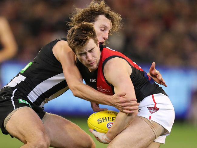 AFL Round 23. 23/08/2019.  Collingwood v Essendon at the MCG.    Essendon's Zach Merrett  tackled by Collingwood's Chris Mayne  3rd quarter   . Pic: Michael Klein