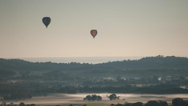 Hot air balloon takes off into the air at sunrise over the Byron hinterland. Picture: Destination NSW