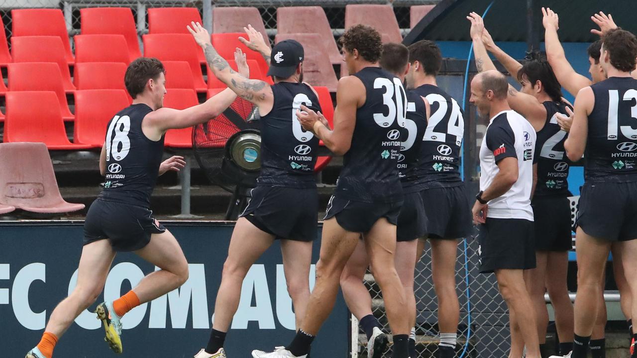 Walsh is cheered on by teammates as he runs the boundary. Picture: David Crosling