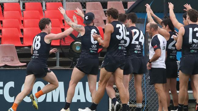 Walsh is cheered on by teammates as he runs the boundary. Picture: David Crosling