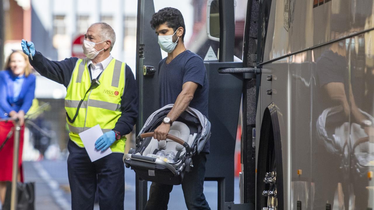 Passengers arrive at the Playford Hotel to start a 14 days of supervised quarantine after arriving in Adelaide on a mercy flight from Mumbai. Picture: Kelly Barnes