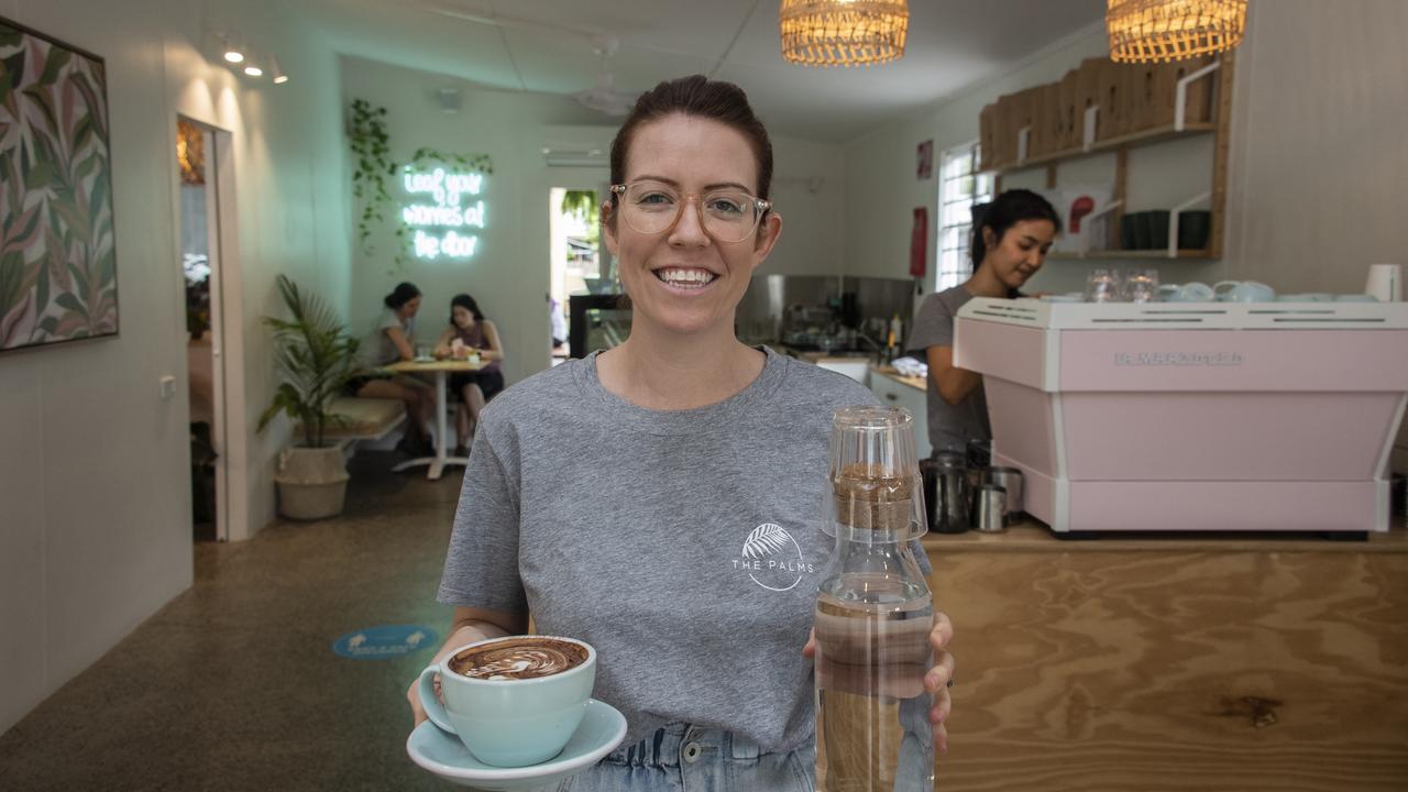 Last year, Jacqui Barber took a punt. She quit her job in tertiary education and bought a vacant and untidy isolated shop in the Cairns suburb of Aeroglen. After sprucing it up, in October she opened ‘The Palms’, an up-market cafe and floral homewares shop.Then Covid hit. ‘The Palms’ closed for three weeks during the initial lockdown but then opened for takeaways only to try and give their Thai barista&#149; Ryikarn Hattakit (in the background) some hours on her working visa. Picture: Brian Cassey