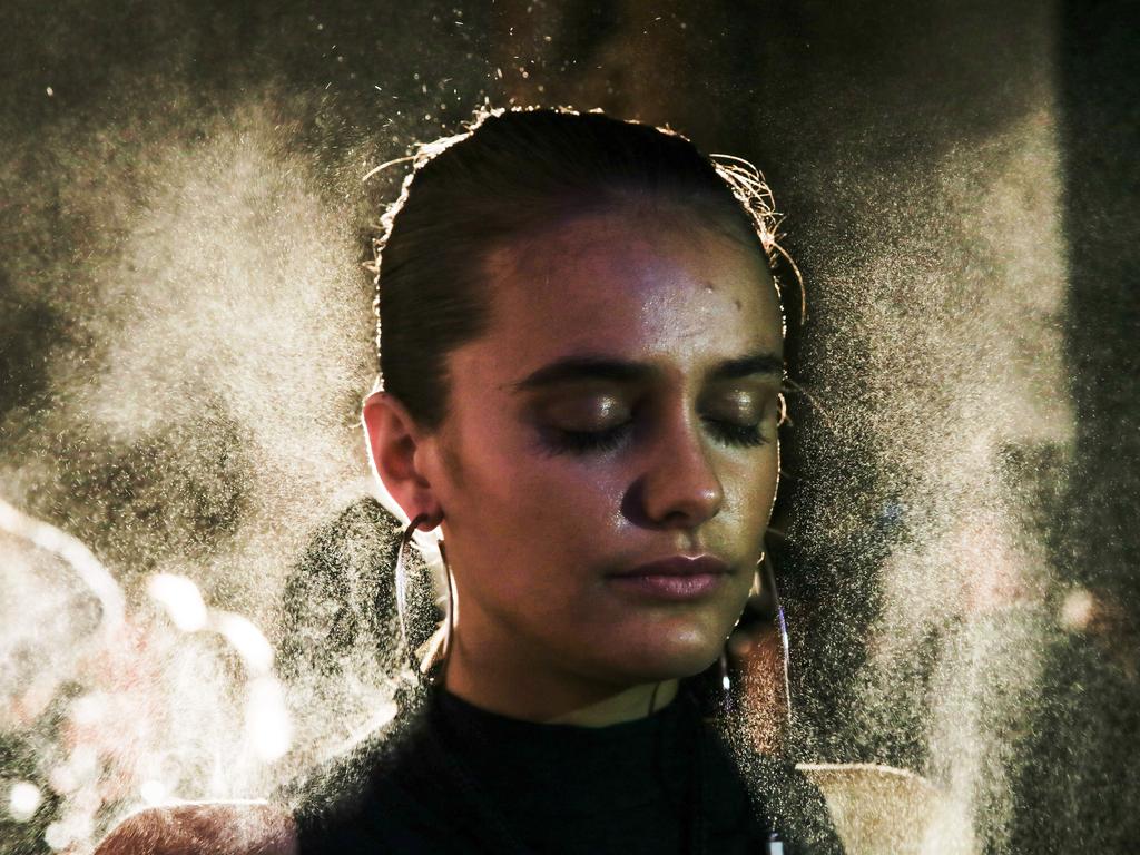 Behind the scenes at Fashion Week at Carriageworks. Julia Gardell gets sprayed. Picture: Dylan Robinson