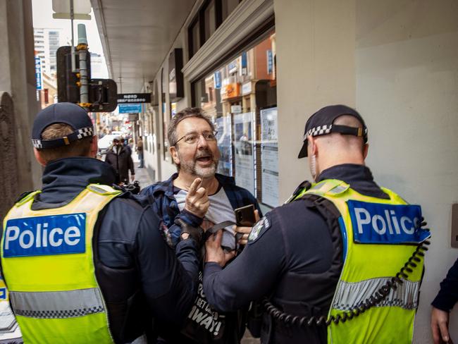 A man is restrained by police during the pro-Palestine rally in Melbourne. Picture: NewsWire