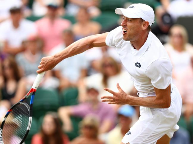 LONDON, ENGLAND - JULY 04:  John Millman of Australia serves against Milos Raonic of Canada during their Men's Singles second round match on day three of the Wimbledon Lawn Tennis Championships at All England Lawn Tennis and Croquet Club on July 4, 2018 in London, England.  (Photo by Matthew Stockman/Getty Images)