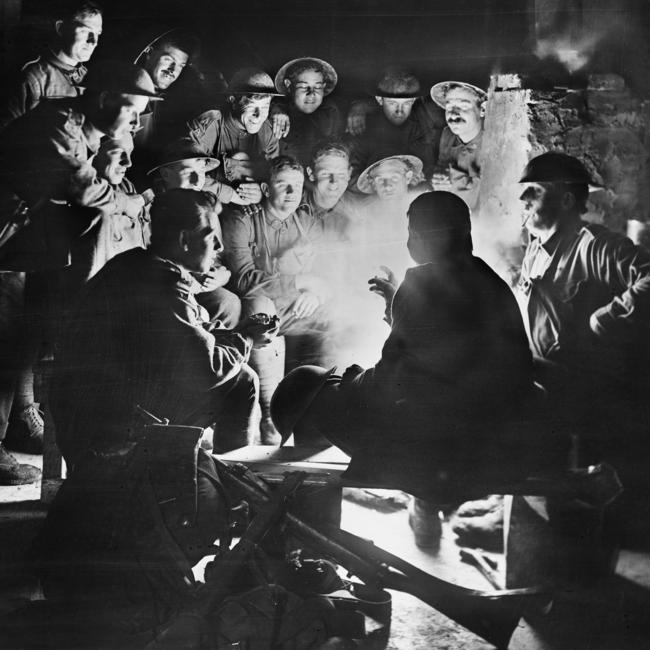 What lies behind their smiles? … Australian soldiers share stories in a dugout at Ypres, on the Western Front, pictured in 1917 by the famous war photographer James ‘Frank’ Hurley.