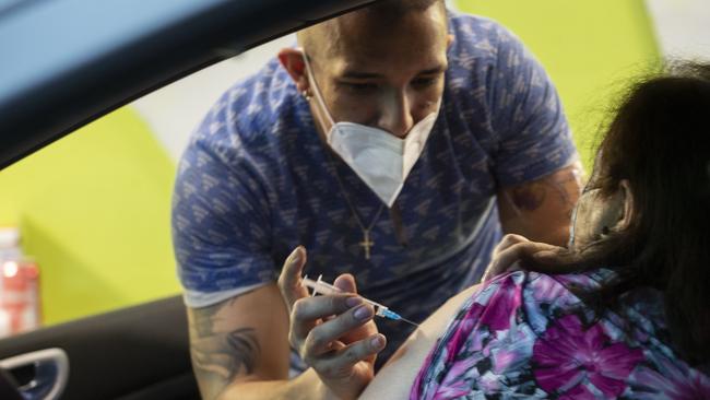 A health worker administers a COVID-19 vaccine to a person in a car in Santiago, Chile. Picture: Getty