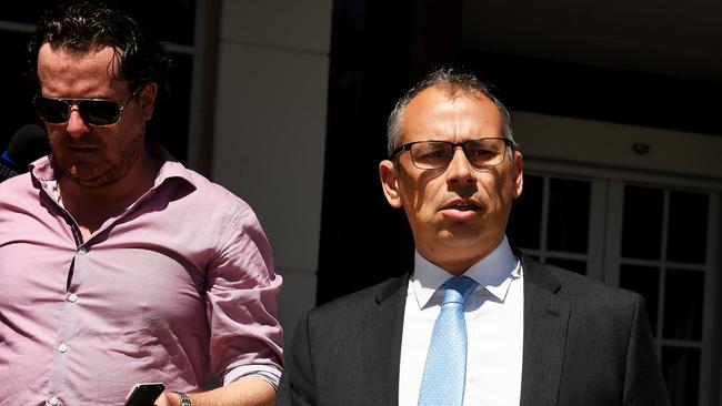 Former NT Chief Minister Adam Giles, right,  leaves the Darwin Supreme Court on Wednesday