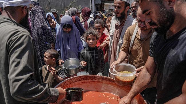 Palestinians queue for food at a public kitchen in Deir el-Balah in the central Gaza Strip. Picture: AFP