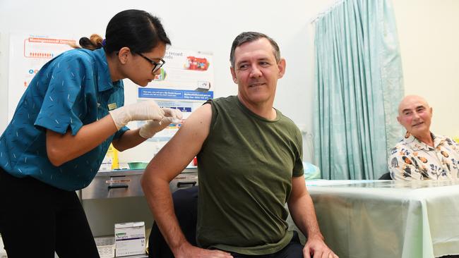 Chief Minister Michael Gunner receives the first dose of the coronavirus vaccine, with nurse Nizma Tamrakar. Picture Katrina Bridgeford.