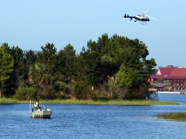 Florida Fish and Wildlife and an Orange County Sheriffs helicopter search for the young boy. Picture: Red Huber/Orlando Sentinel